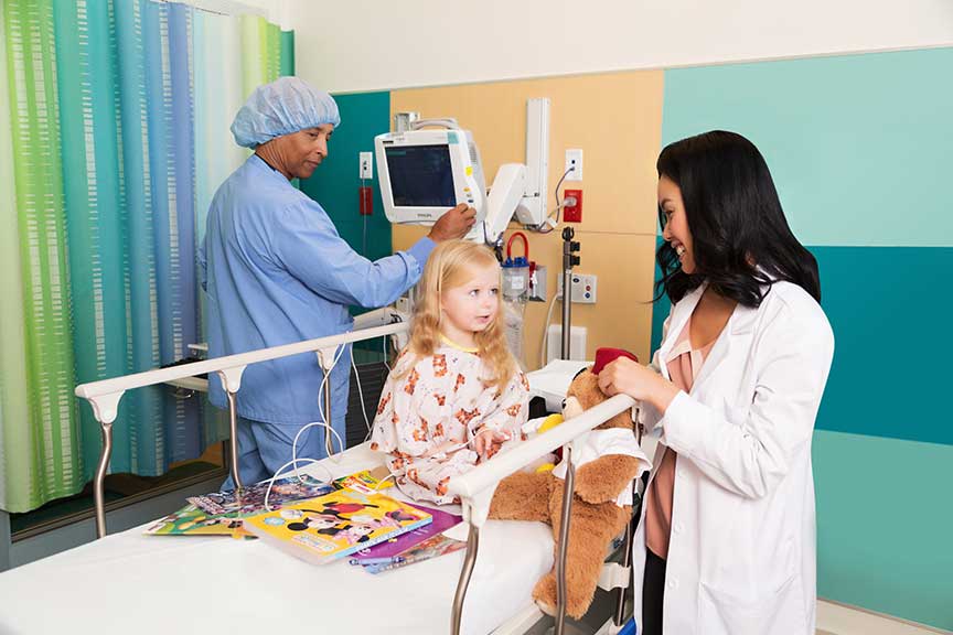 Image of doctor and nurse with child patient